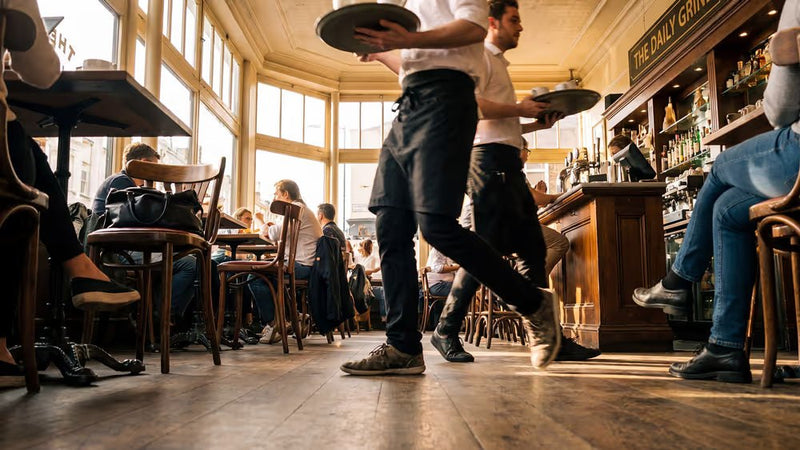 Busy restaurant dining room full of guests during service