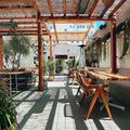 Rockless Table T-Bases under bar height tables at a waterfront restaurant with uneven decking